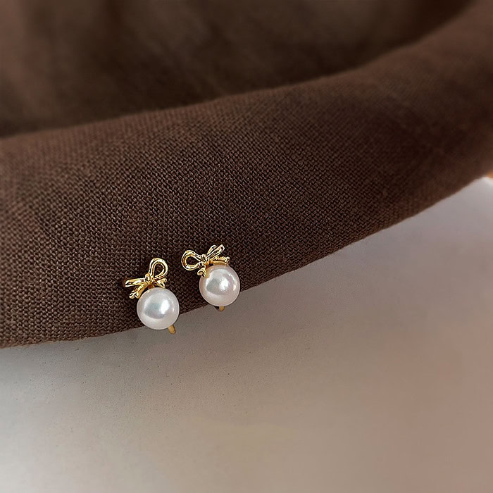 Gold Bow Ohrclips mit Perlen